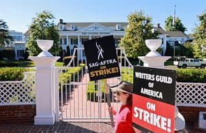 someone holding a sign about the writer's strike